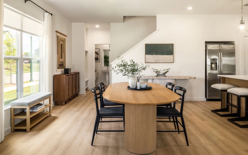 large dining table and chairs next to a window in a rental townhome in Rowlett