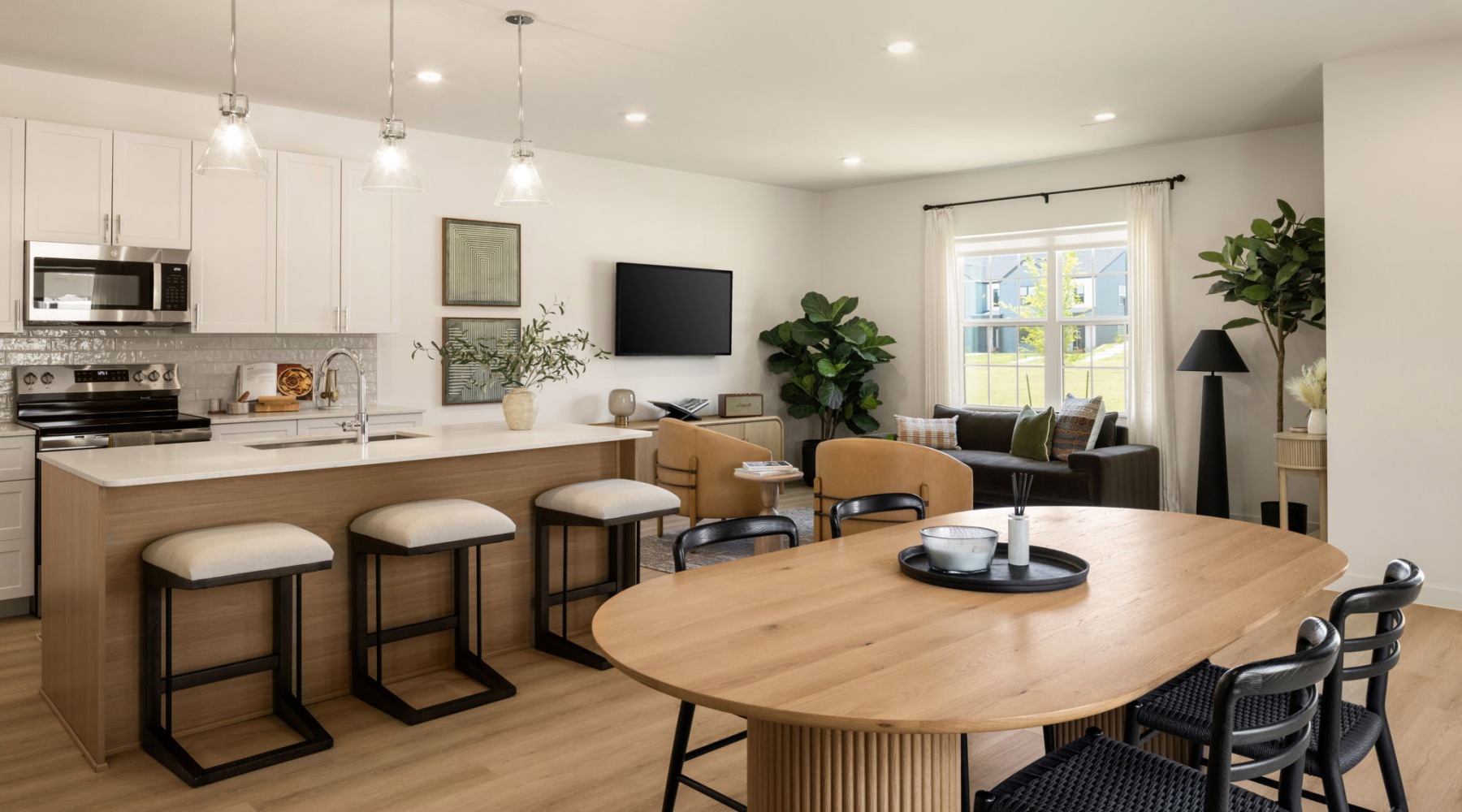 a large white kitchen with a dining table in a rental townhome of a BTR community