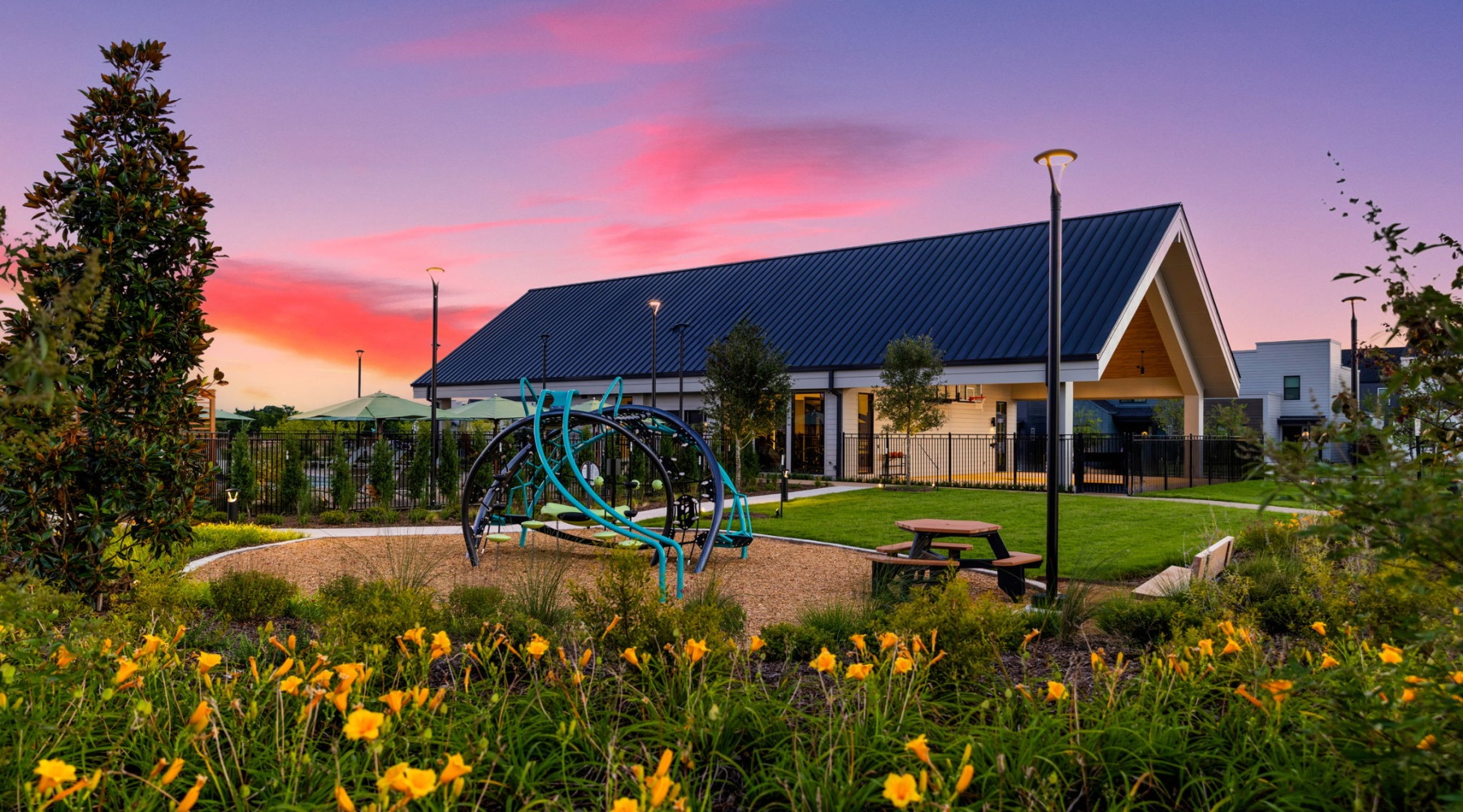 a playground and lawn in front of a community club house for residents in Fort Worth