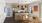 a kitchen with a dining table and a refrigerator