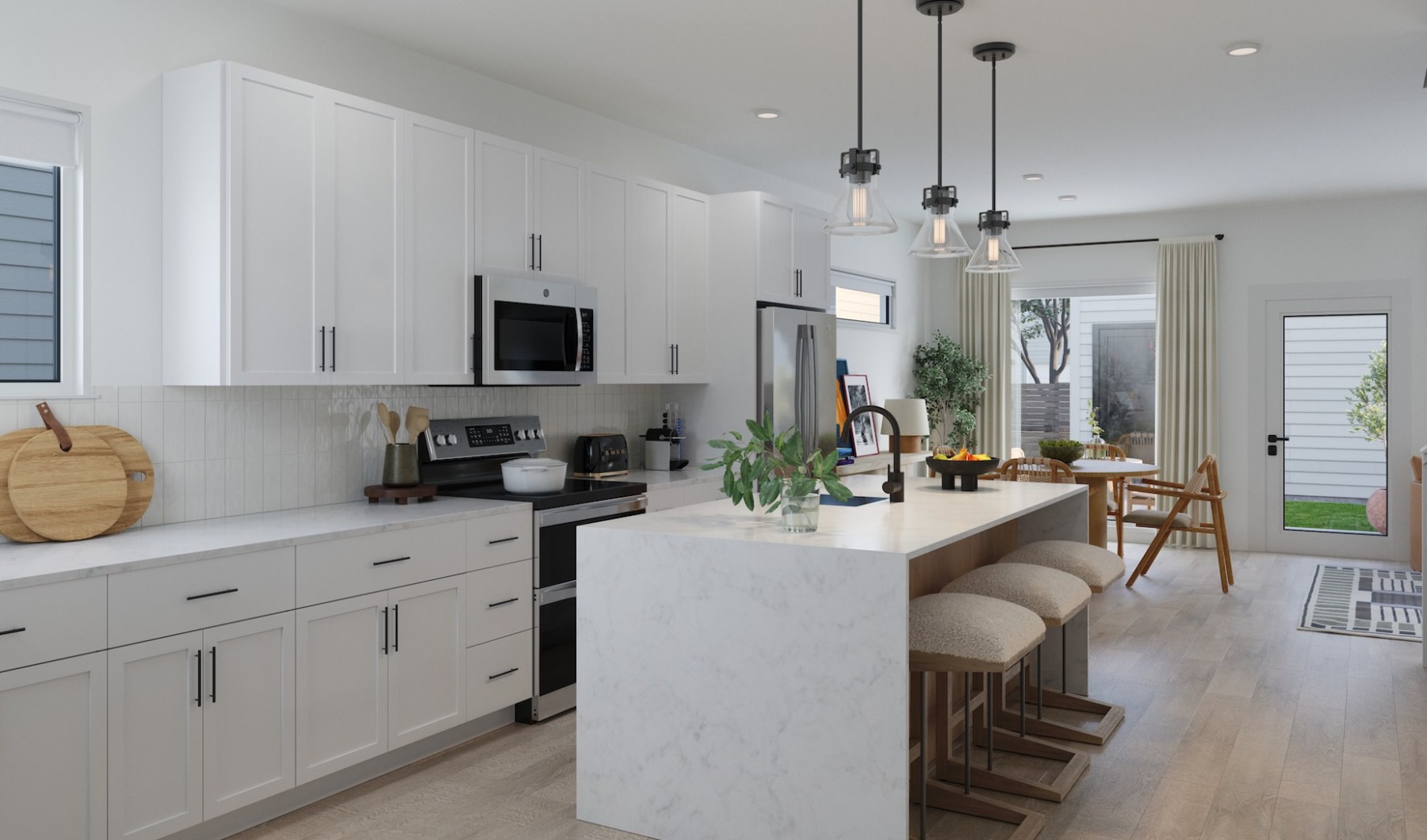 An open concept design allows for flawless entertaining.  kitchen with white cabinets and a waterfall edge island