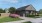 a house with a lawn and a large driveway