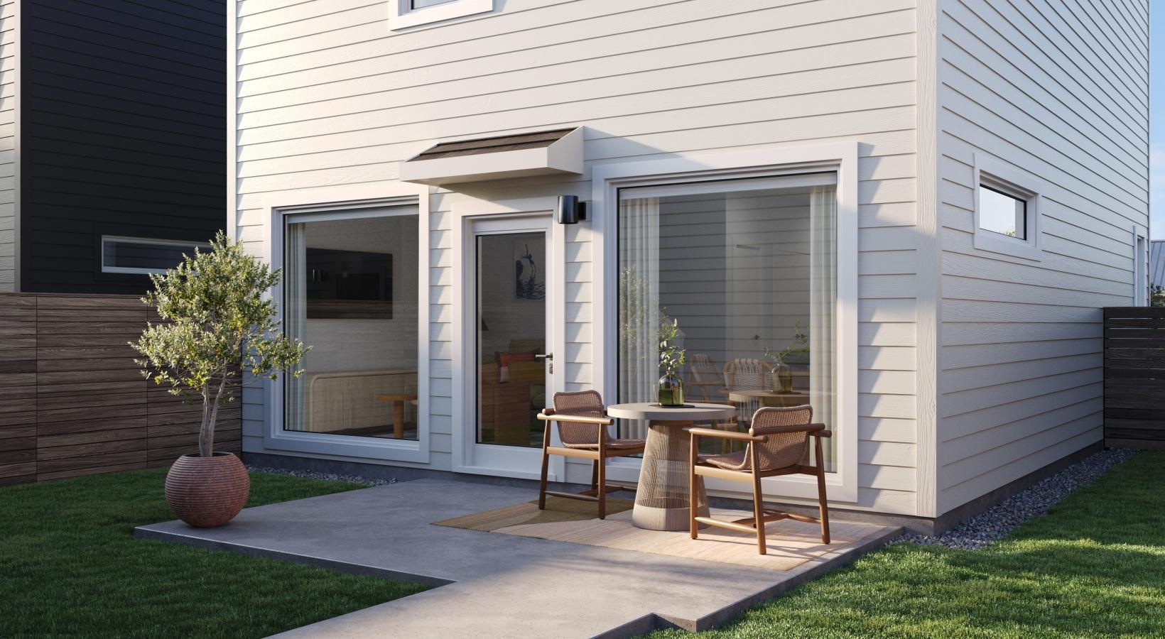 Spacious and well-lit living spaces a house with a patio and a table and chairs